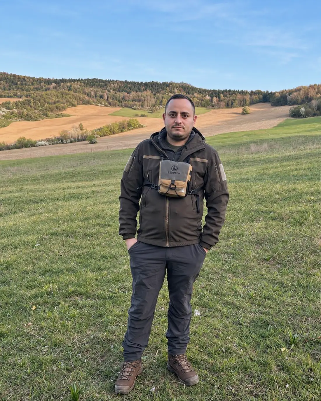 The founder of Carpathian Reserve standing in a spring meadow in the Transylvanian hills